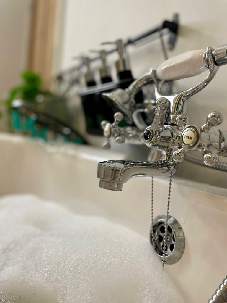 Bathroom with walk in shower and roll top bath